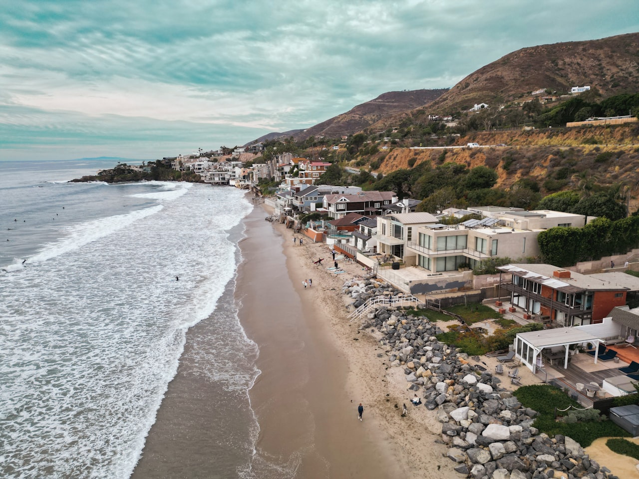 an aerial view of a beach with houses on it